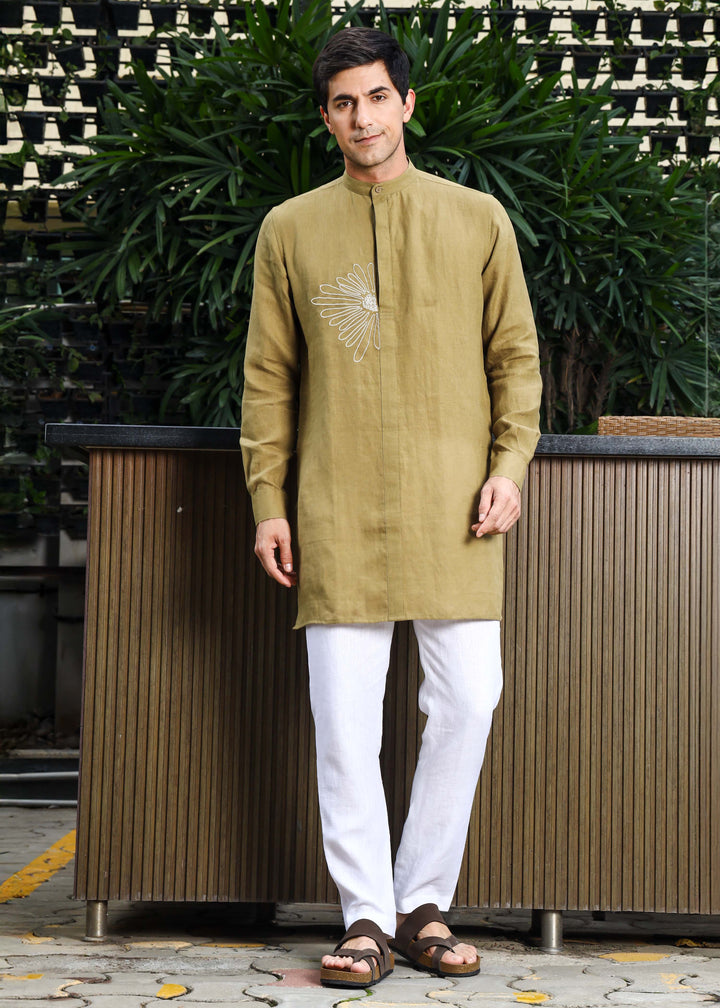 Man wearing a 100% pure linen 60 LEA sunburst yellow kurta against a green leafy background