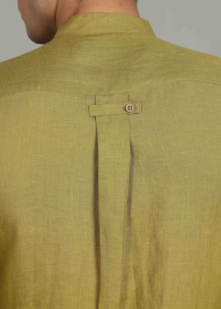 Close-up of a 100% pure linen sap green full sleeve shirt in 60 LEA with a button on a gray background