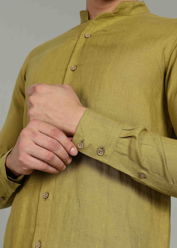 100% pure linen sap green full sleeve shirt in 60 LEA with buttons being adjusted against a neutral background
