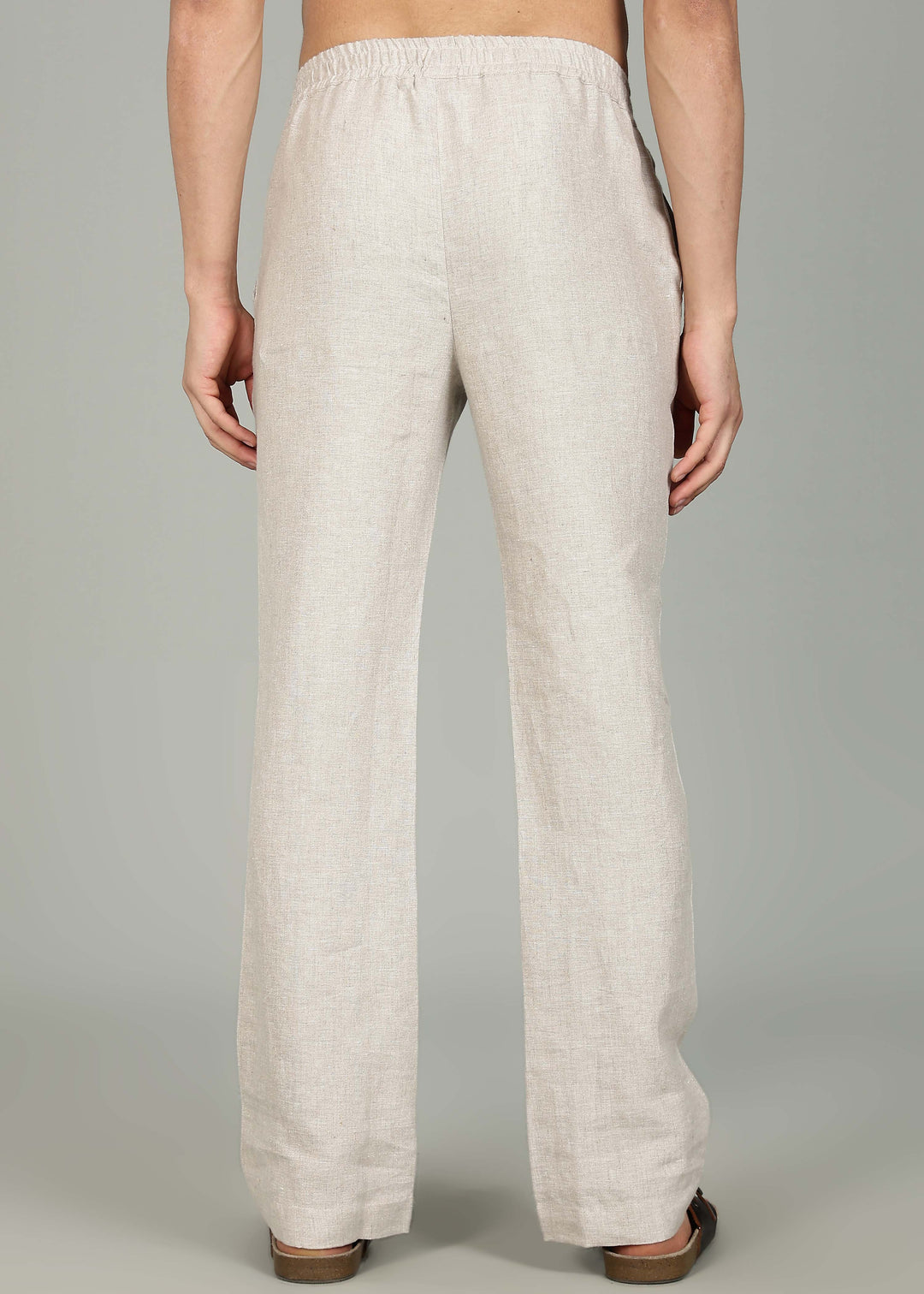 100% pure linen ecru pants in 25 LEA worn by a person on a gray background