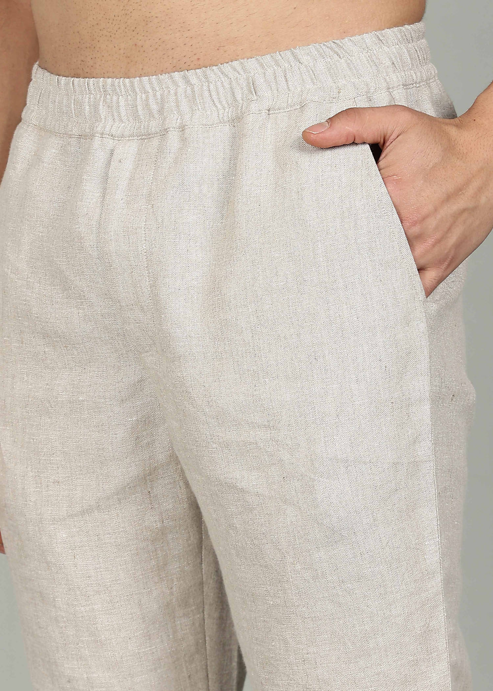100% pure linen ecru pants in 25 LEA worn by a person on a gray background